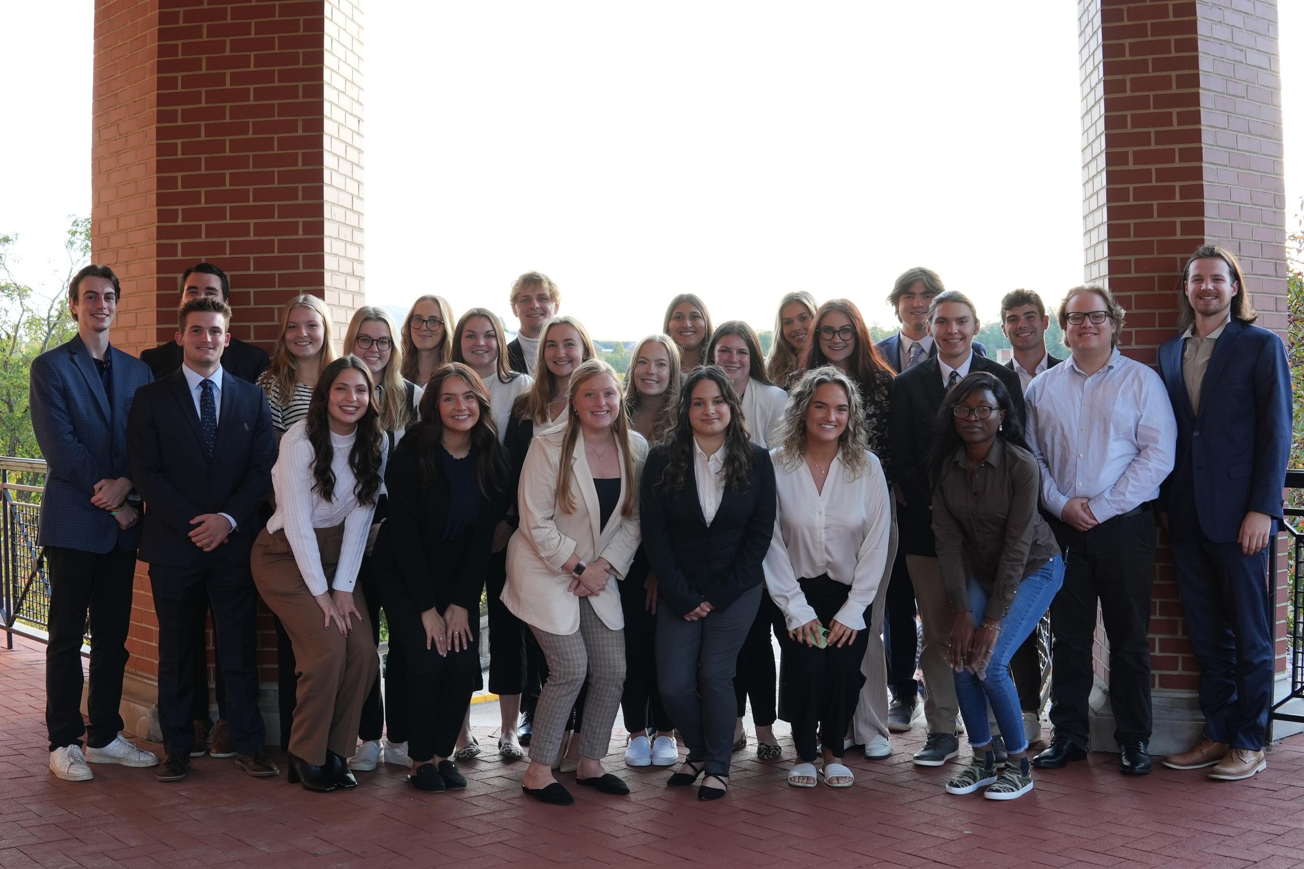 Photograph of students in the CRA posing for a group photo in business professional attire.