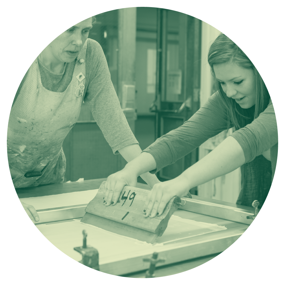 Teacher observing student screen printing