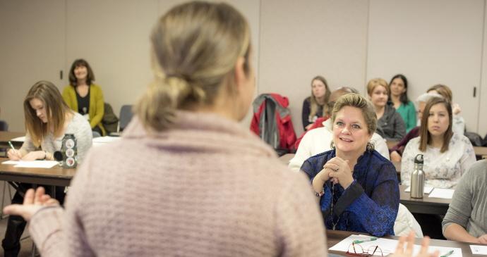 Woman speaking to crowd in room